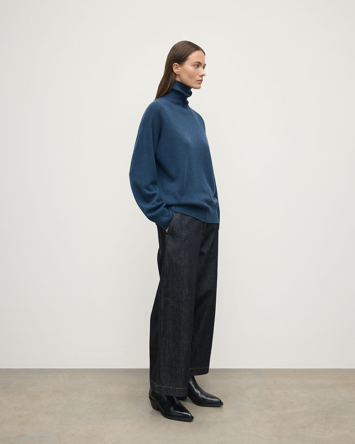 Model wears Johnstons of Elgin AW25 Women's Knitwear Heather Navy Gauzy Cashmere Roll Neck Side View KAI05324HD7321