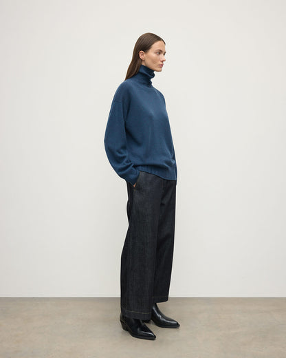 Model wears Johnstons of Elgin AW25 Women's Knitwear Heather Navy Gauzy Cashmere Roll Neck Side View KAI05324HD7321