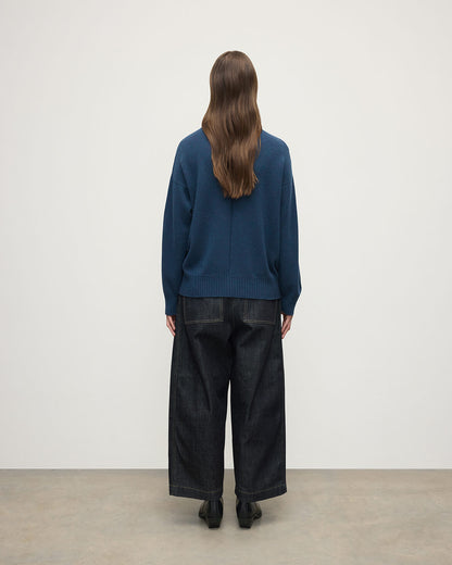 Model wears Johnstons of Elgin AW25 Women's Knitwear Heather Navy Gauzy Cashmere Roll Neck Back View KAI05324HD7321