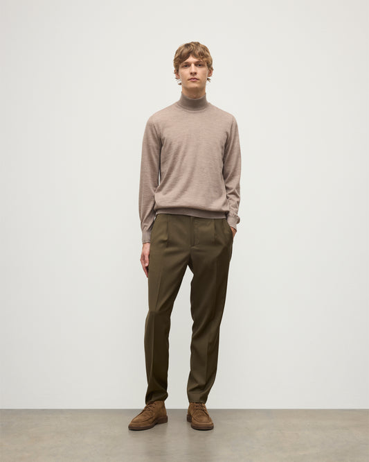 MODEL WEARING JOHNSTONS OF ELGIN MENS SUPERFINE FIN ROLL COLLAR GREY 100% SUPERFINE CASHMERE WITH OLIVE TROUSERS KAI05333HB0273