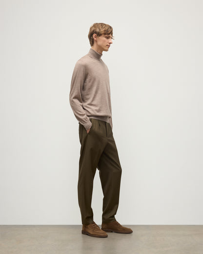 MODEL WEARING JOHNSTONS OF ELGIN MENS SUPERFINE FIN ROLL COLLAR GREY 100% SUPERFINE CASHMERE WITH OLIVE TROUSERS KAI05333HB0273