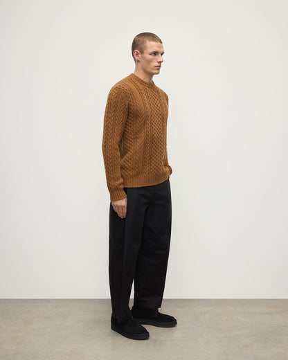 Side view of model wearing Johnstons of Elgin AW25 Men's Knitwear Dark Camel Aran Cable Camel Cashmere Jumper KAI05336SB4620