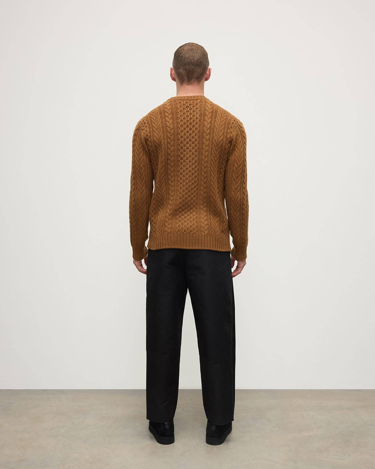 Back view of model wearing Johnstons of Elgin AW25 Men's Knitwear Dark Camel Aran Cable Camel Cashmere Jumper KAI05336SB4620