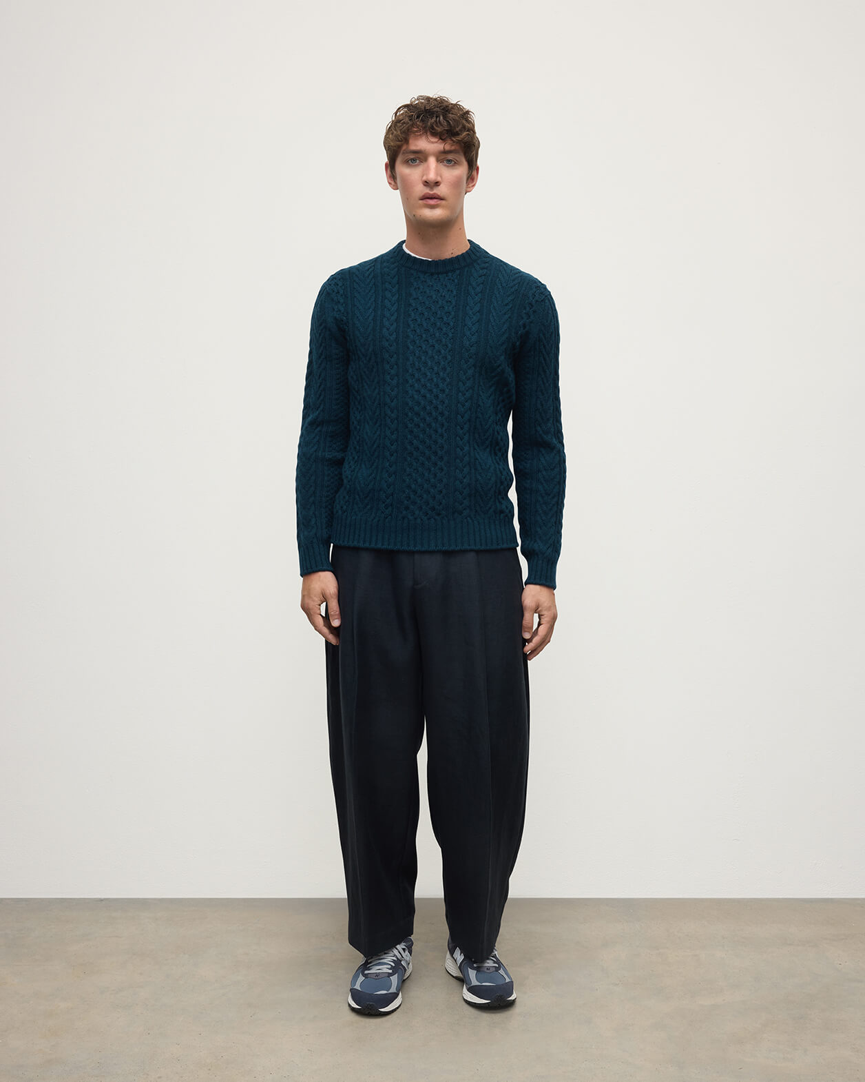 Model wearing Johnstons of Elgin AW25 Men's Knitwear Bottle Green Aran Cable Green Cashmere Jumper Front KAI05336SC7341