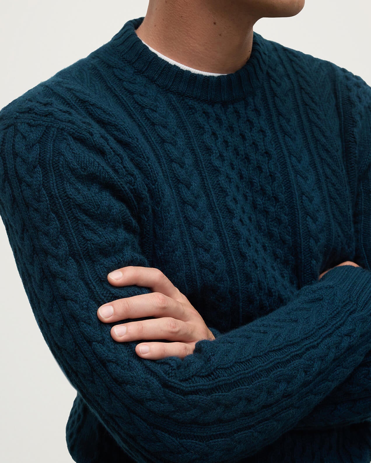 Model wearing Johnstons of Elgin AW25 Men's Knitwear Bottle Green Aran Cable Green Cashmere Jumper Close Up KAI05336SC7341