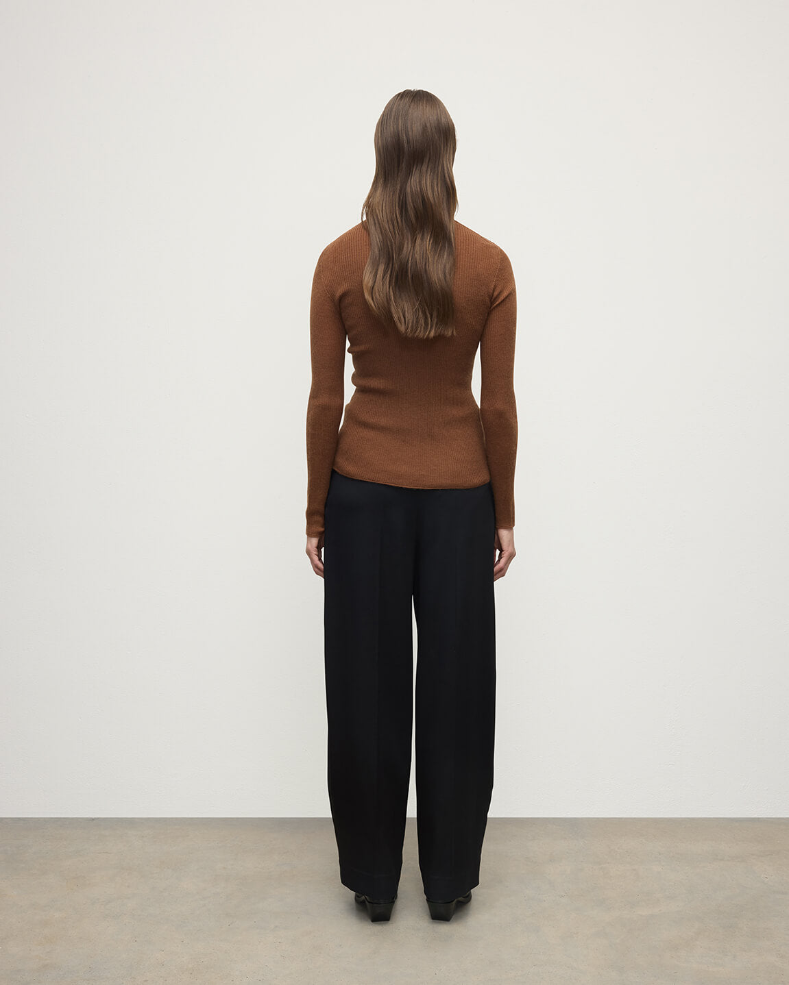 Model wearing Johnstons of Elgin AW25 Women's Knitwear Dark Camel Superfine Cashmere Camel Cardigan Back View KAI05372SB7300