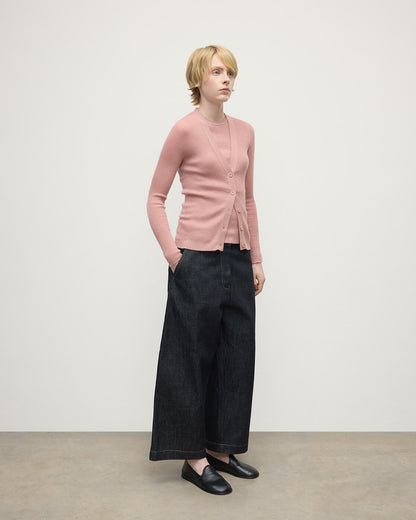 Model wears Johnstons of Elgin AW25 Women's Knitwear Nude Superfine Cashmere Pink Cardigan Side View KAI05372SE5274