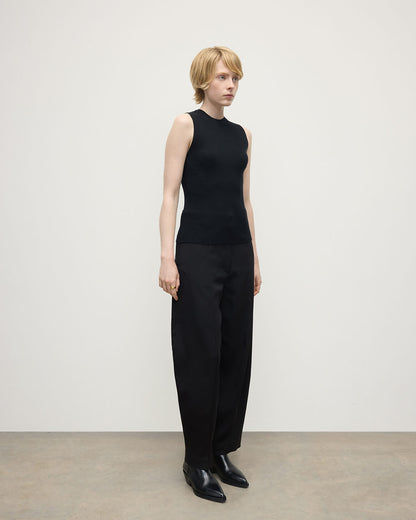 model wears Johnstons of Elgin AW25 Women's Knitwear Black Sleeveless Black Tank Top side view KAI05559SA7146