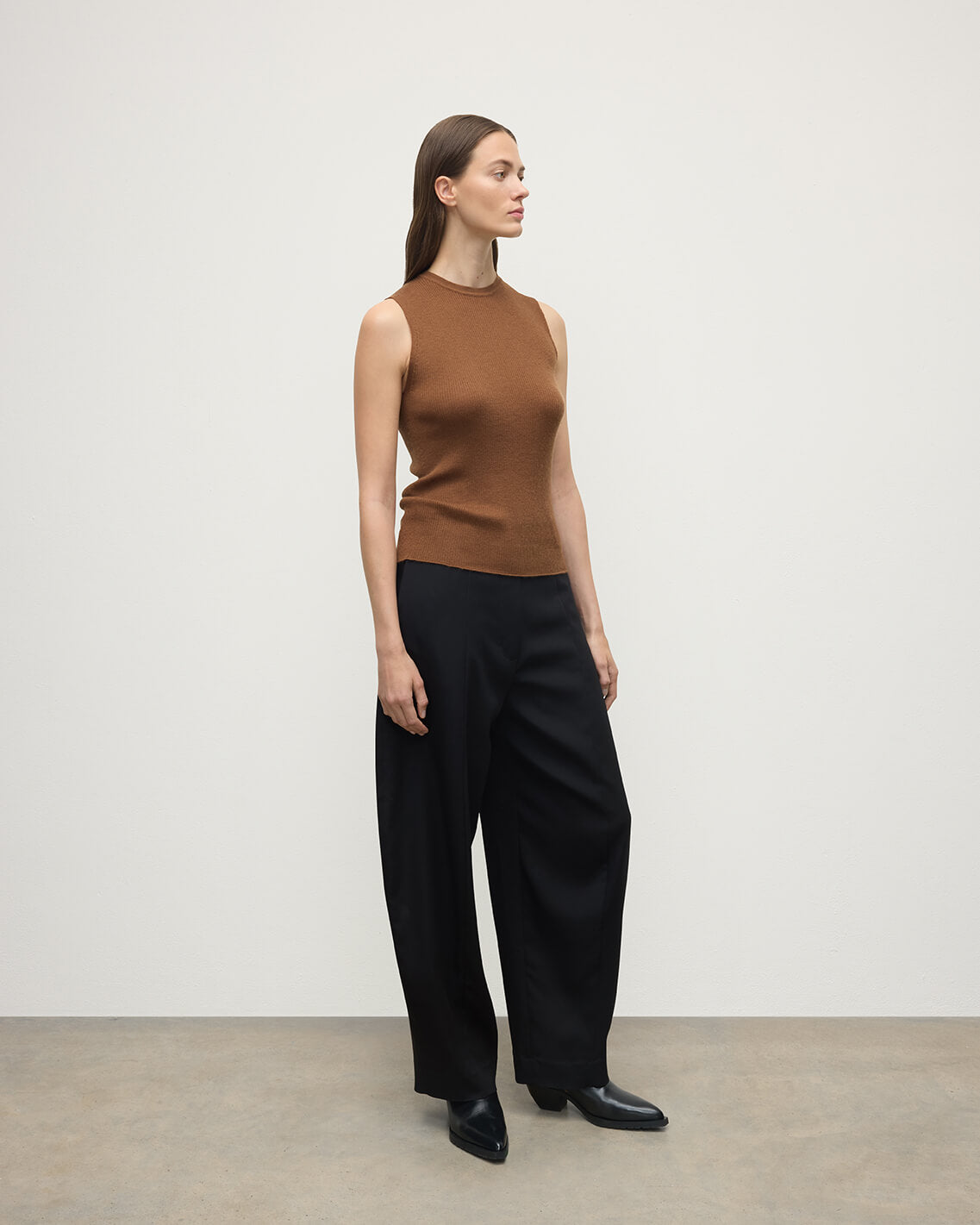 Model wears Johnstons of Elgin AW25 Women's Knitwear Dark Camel Sleeveless Camel Tank Top Front View KAI05559SB7300