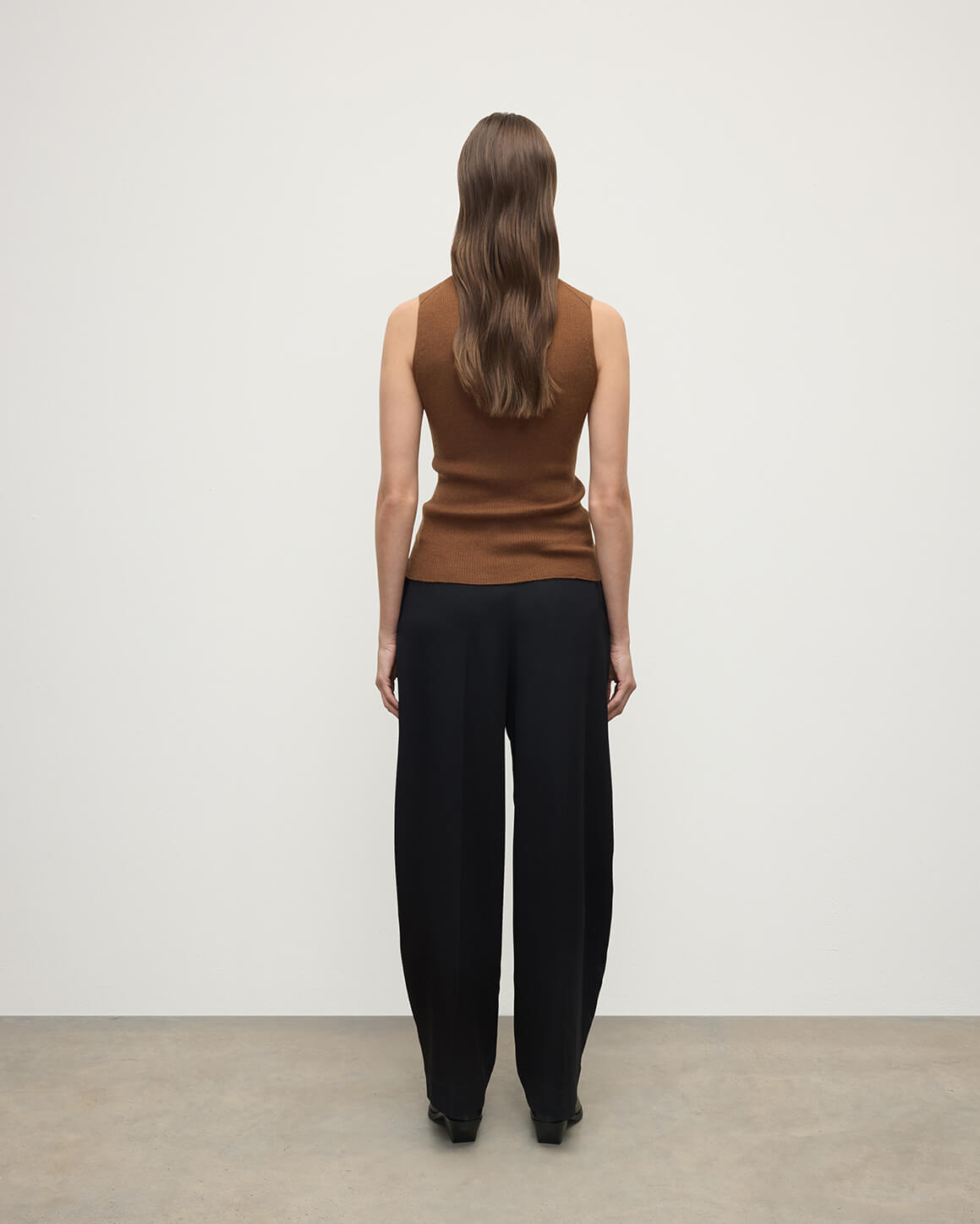 Model wears Johnstons of Elgin AW25 Women's Knitwear Dark Camel Sleeveless Camel Tank Top Back View KAI05559SB7300
