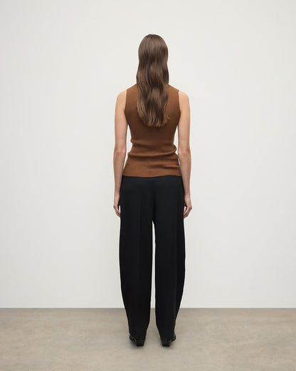 Model wears Johnstons of Elgin AW25 Women's Knitwear Dark Camel Sleeveless Camel Tank Top Back View KAI05559SB7300