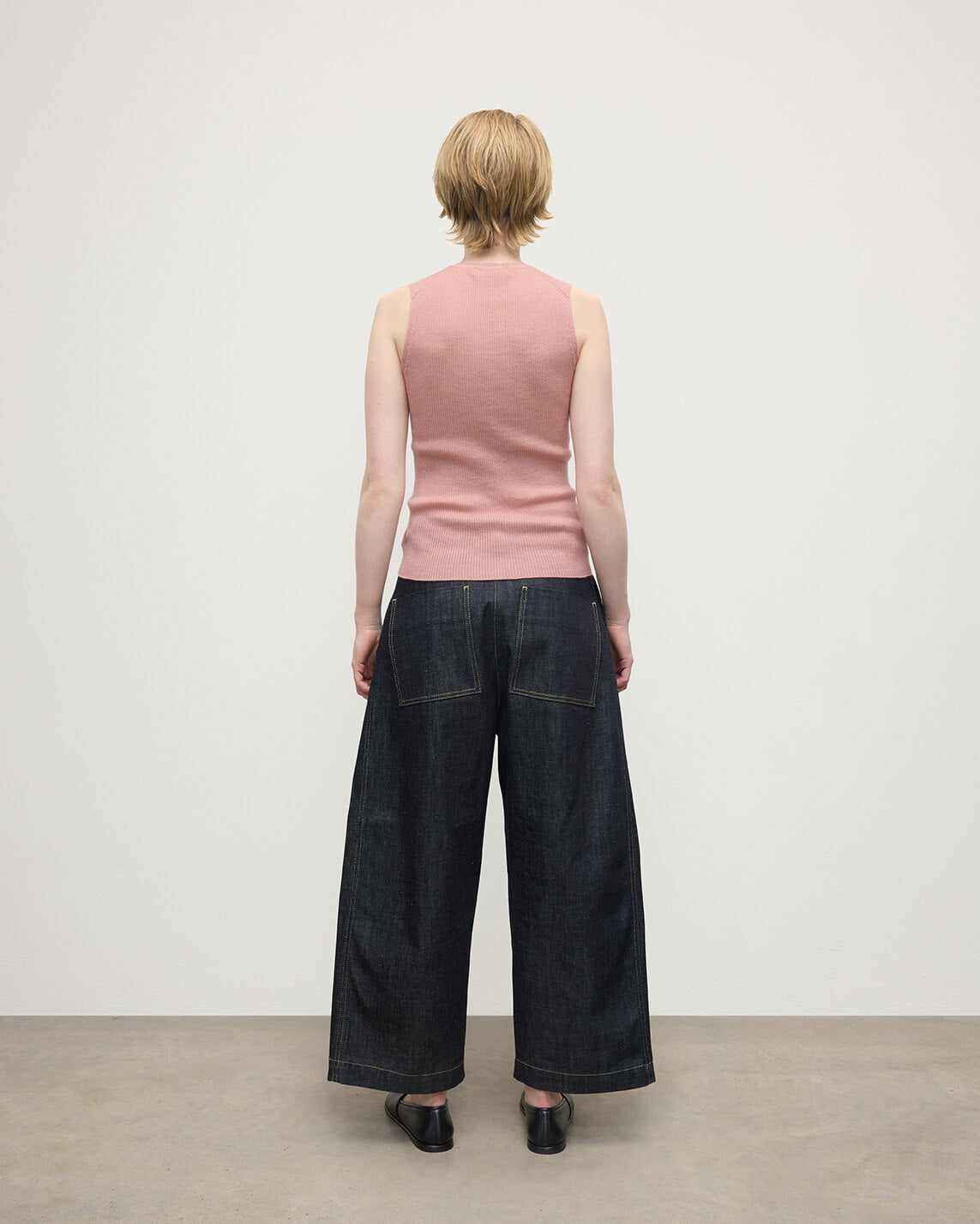 model wears Johnstons of Elgin AW25 Women's Knitwear Nude Sleeveless Pink Tank Top Back View KAI05559SE5274