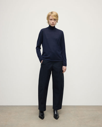 Model wears Johnstons of Elgin AW25 Women's Knitwear Dark Navy Superfine Cashmere Navy Roll Neck Jumper Front View KAI05607SD7600