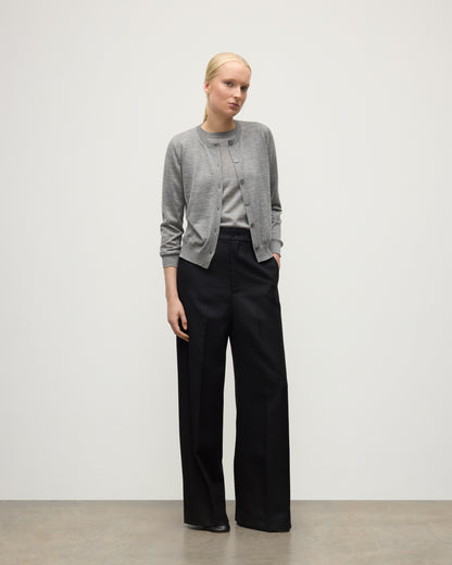 MODEL WEARING JOHNSTONS OF ELGIN WOMENS HONOR CREW CARDIGAN GREY 100% SUPERFINE CASHMERE OVER A MATCHING T-SHIRT WITH BLACK TROUSERS KAI05708HA4253