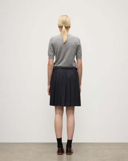 BACK VIEW OF A MODEL WEARING JOHNSTONS OF ELGIN WOMENS HONOR SHORT SLEEVE CREW GREY 100% SUPERFINE CASHMERE WITH SHORT LE KILT CHARCOAL KILT  KAI05712HA4253