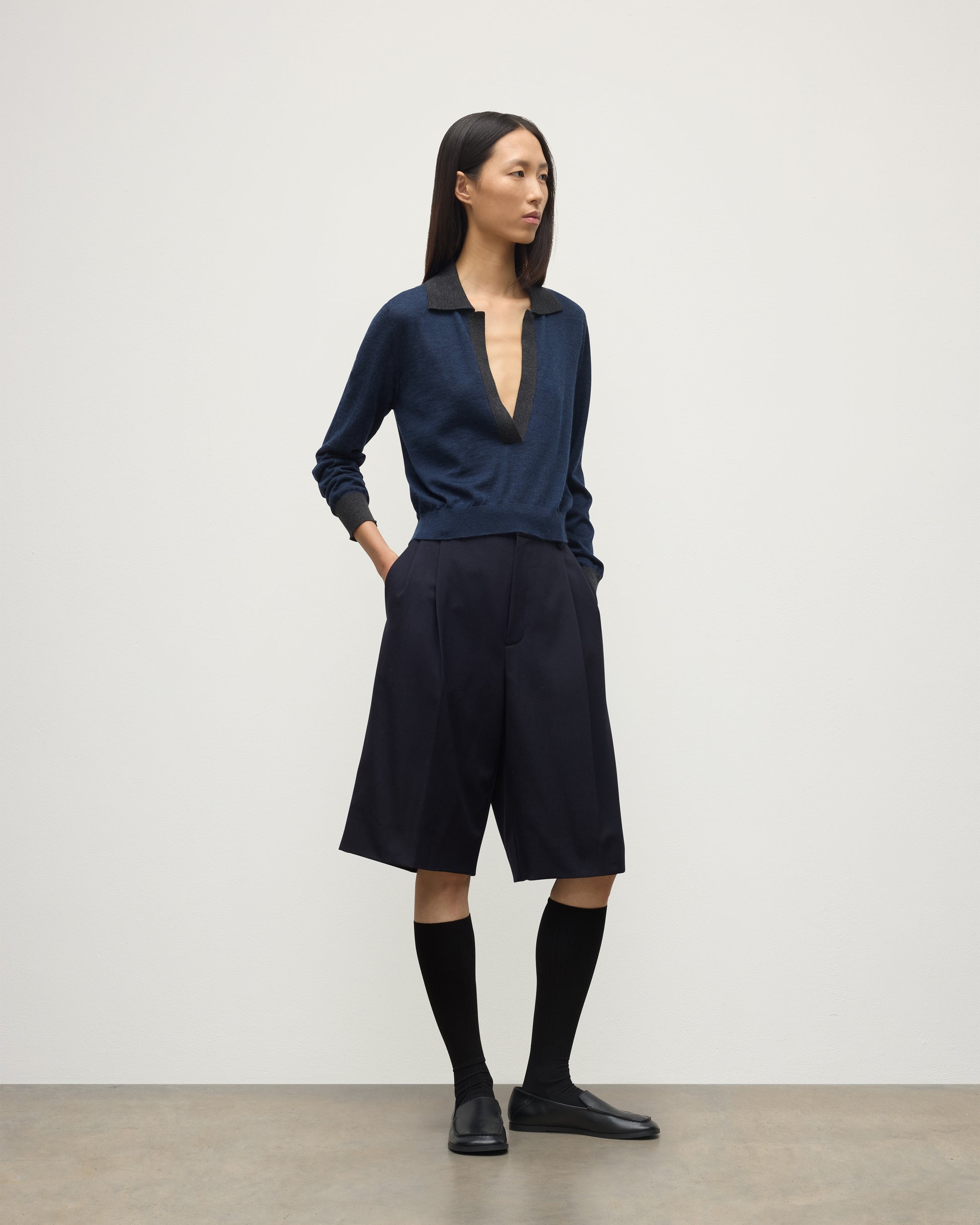 MODEL WEARS JOHNSTONS OF ELGIN WOMENS DEE SHIRT NAVY & GREY 100% SUPERFINE CASHMERE WITH NAVY LONG SHIRTS< SOCKS AND LOAFERS KAI05713Q25962