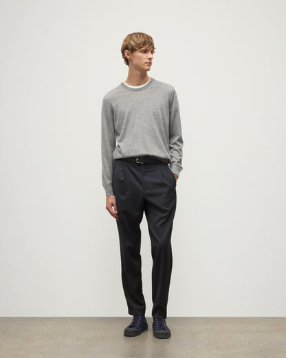MODEL WEARS JOHNSTONS OF ELGIN MENS FIN SUPERFINE CREW GREY 100% SUPERFINE CASHMERE  OVER A WHITE T-SHIRT WITH GREY TROUSERS KAI05717HA4253
