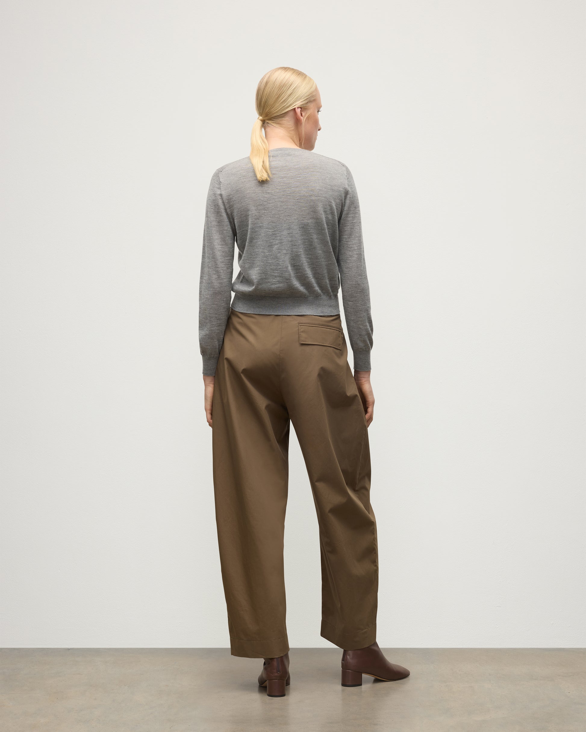 MODELS BACK WEARING JOHNSTONS OF ELGIN WOMENS ELLA SCOOP SWEATER GREY WITH BROWN WIDE LEG TROUSERS AND BROWN BOOTS KAI05723HA4253