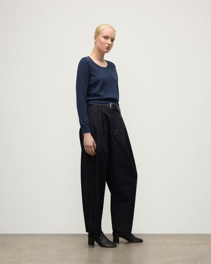 MODEL WEARING JOHNSTONS OF ELGIN WOMENS ELLA SCOOP SWEATER NAVY WITH BLACK TROUSERS AND BOOTS KAI05723HD7350