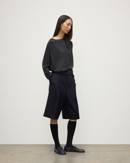 MODEL WEARING JOHNSTONS OF ELGIN WOMENS FINOLA SWEATER GREY 100% SUPERFINE CASHMERE  WITH BLACK LONG SHIRTS, SOCKS AND LOAFERS KAI05789HA7218