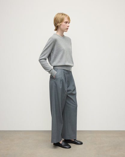 Model wears Johnstons of Elgin AW25 Women's Knitwear Light Grey Classic Cashmere Grey Round Neck Jumper Side KAP05572HA0308