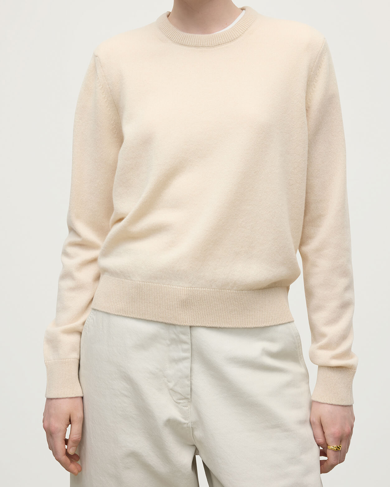model wearing Johnstons of Elgin AW25 Women's Knitwear Champagne Classic Cashmere Cream Round Neck Jumper close up KAP05572SA0502