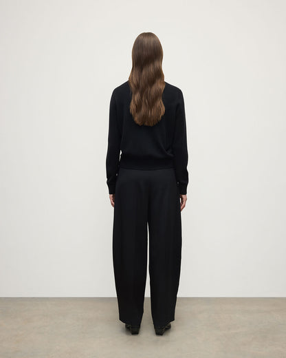 Model wears Johnstons of Elgin AW25 Women's Knitwear Black Classic Cashmere Black Round Neck Jumper Back View KAP05572SA7210
