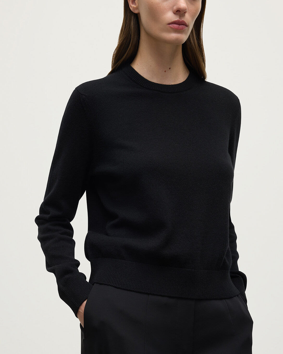 Model wears Johnstons of Elgin AW25 Women's Knitwear Black Classic Cashmere Black Round Neck Jumper close up KAP05572SA7210