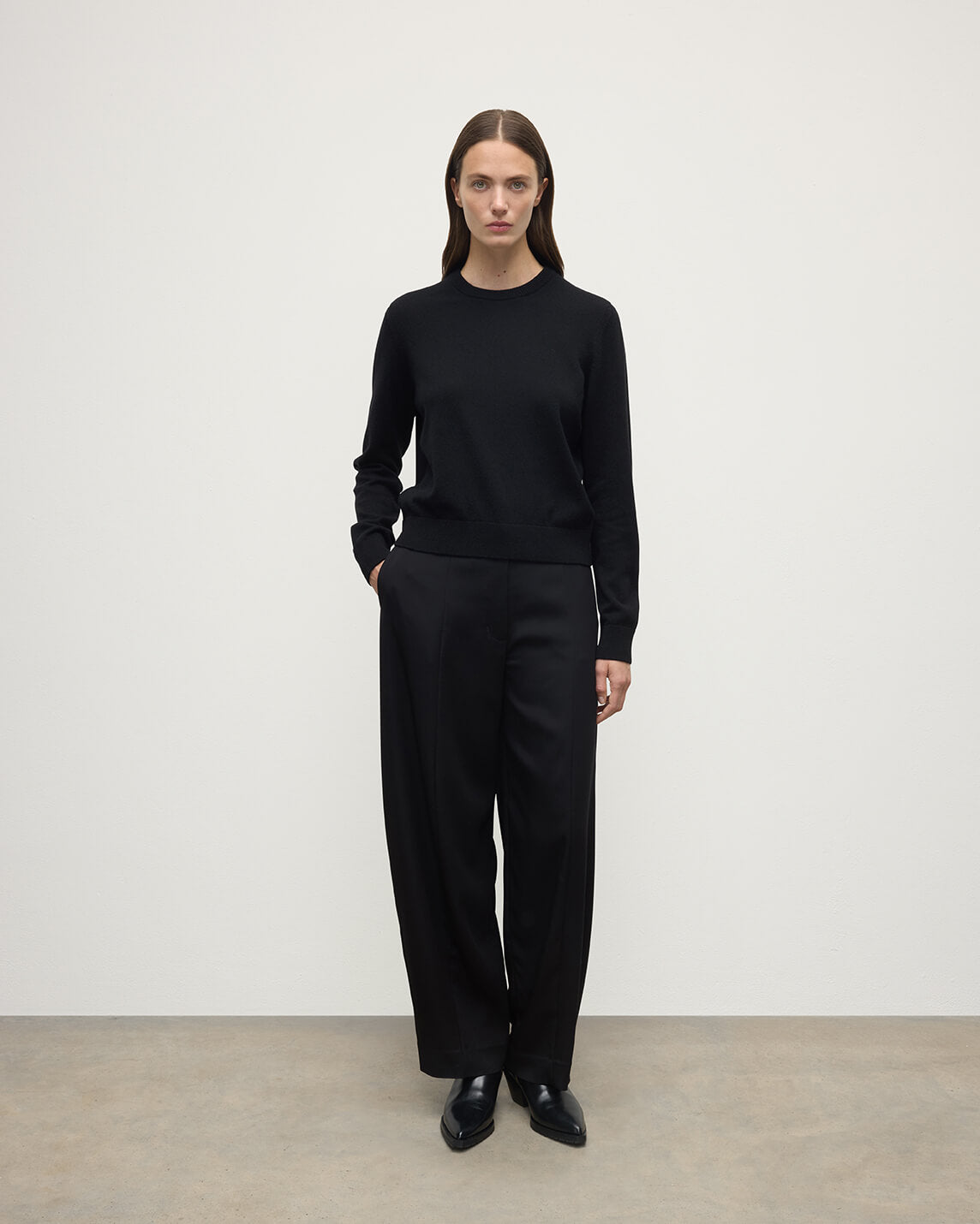 Model wears Johnstons of Elgin AW25 Women's Knitwear Black Classic Cashmere Black Round Neck Jumper Front View KAP05572SA7210