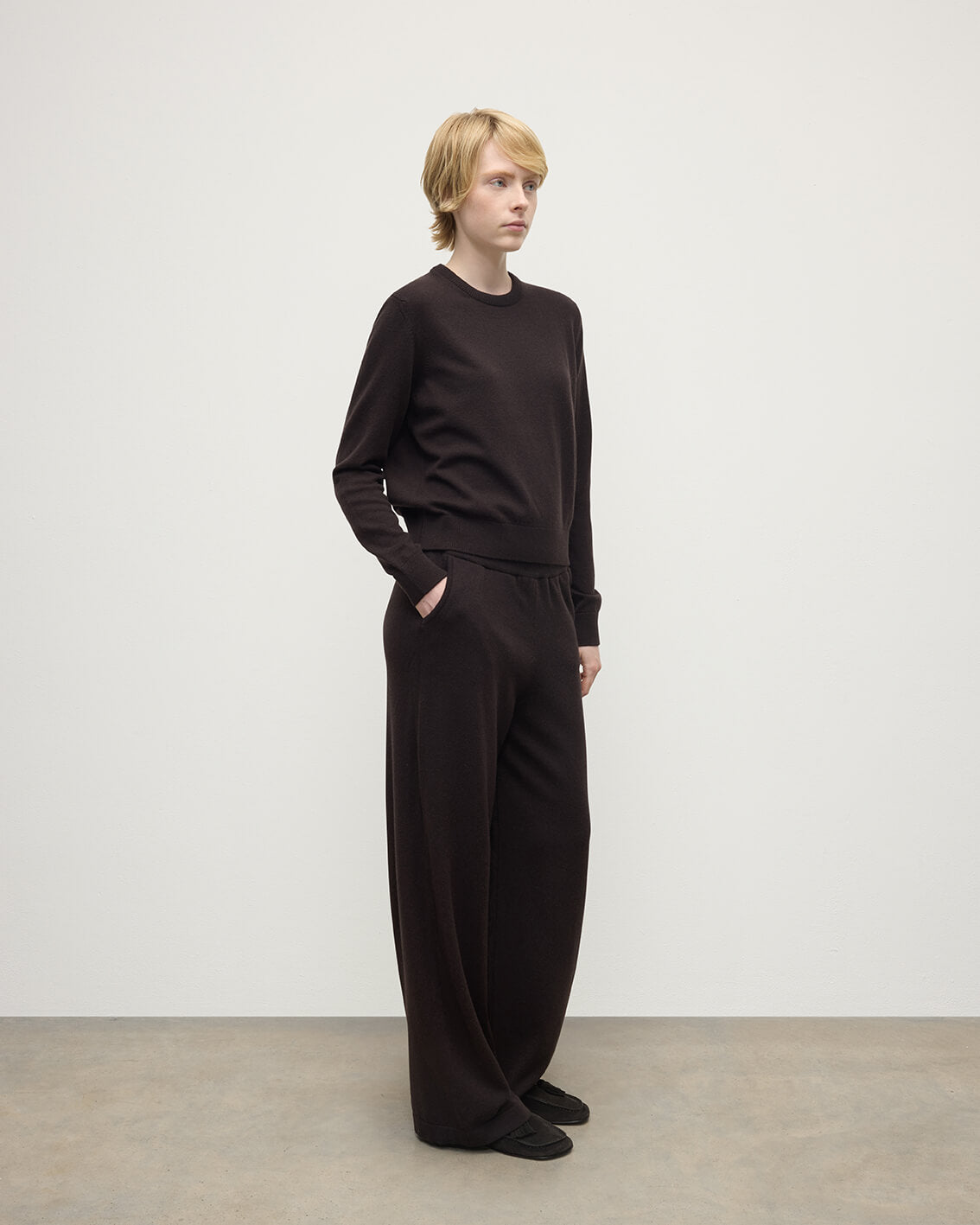 Model wearing Johnstons of Elgin AW25 Women's Knitwear Molasses Classic Cashmere Brown Round Neck Jumper Side View KAP05572SB7290