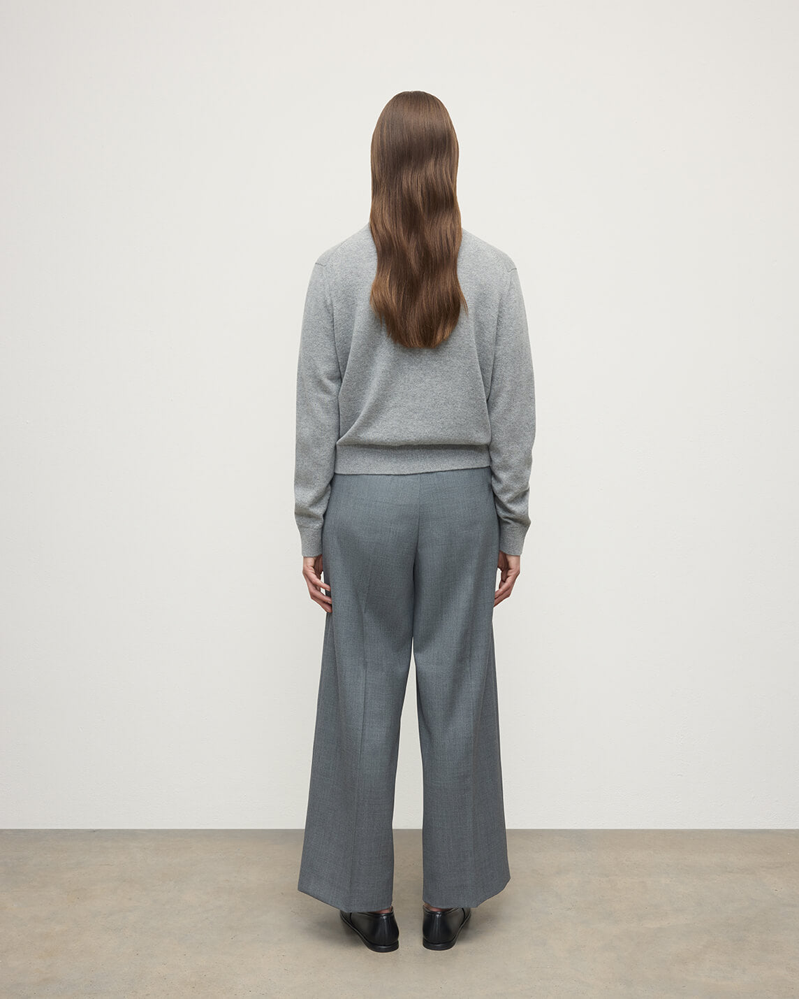 Model wears Johnstons of Elgin AW25 Women's Knitwear Light Grey Classic Cashmere Grey Cardigan Back KAP05573HA0308
