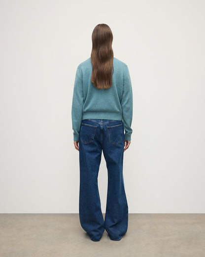 Model wears Johnstons of Elgin AW25 Women's Knitwear Seascape Classic Cashmere Green Cardigan Back KAP05573HC0038