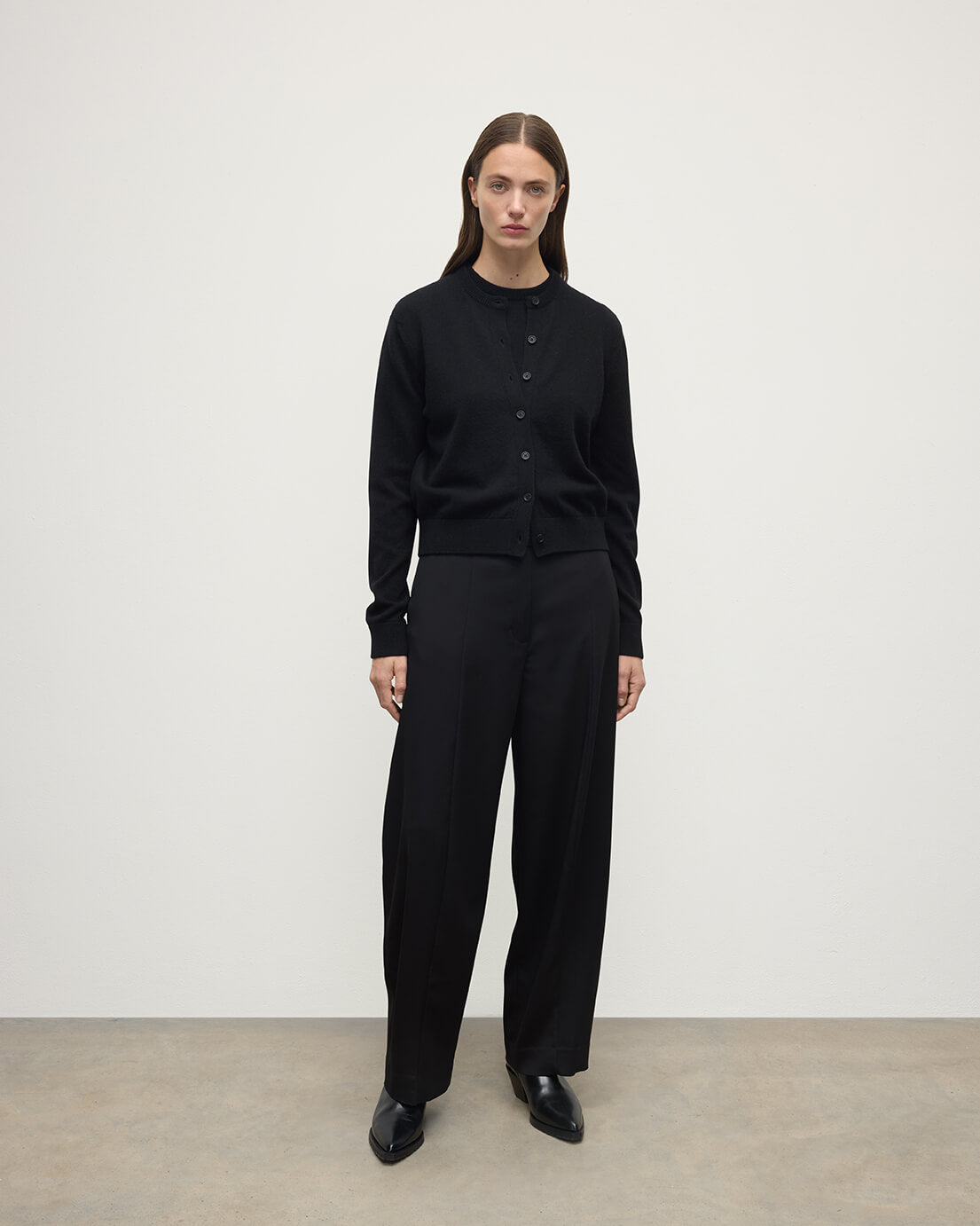 Model wears Johnstons of Elgin AW25 Women's Knitwear Black Classic Cashmere Black Cardigan Front KAP05573SA7210