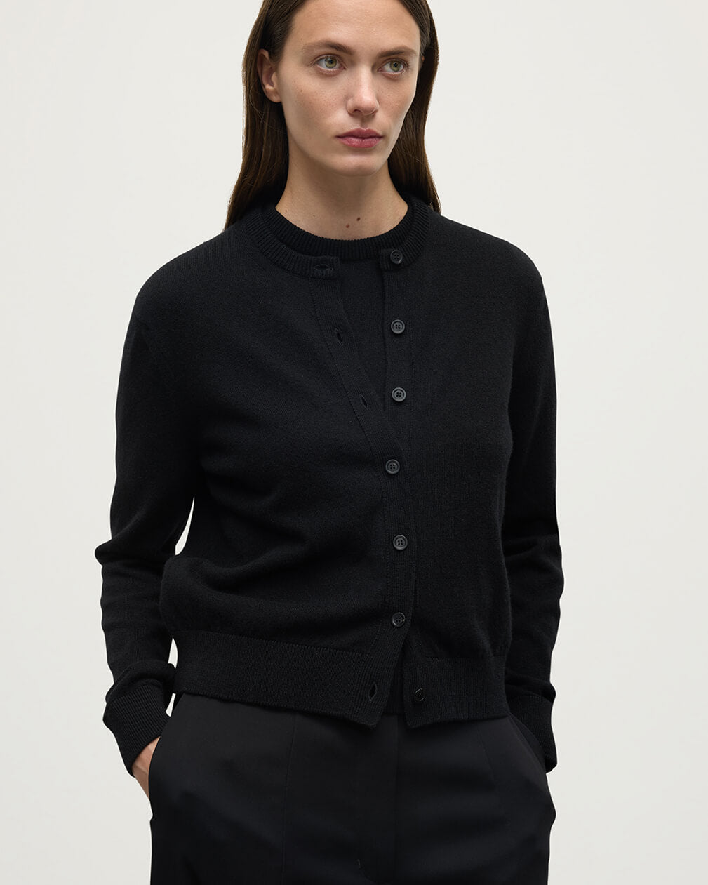 Model wears Johnstons of Elgin AW25 Women's Knitwear Black Classic Cashmere Black Cardigan Close Up KAP05573SA7210