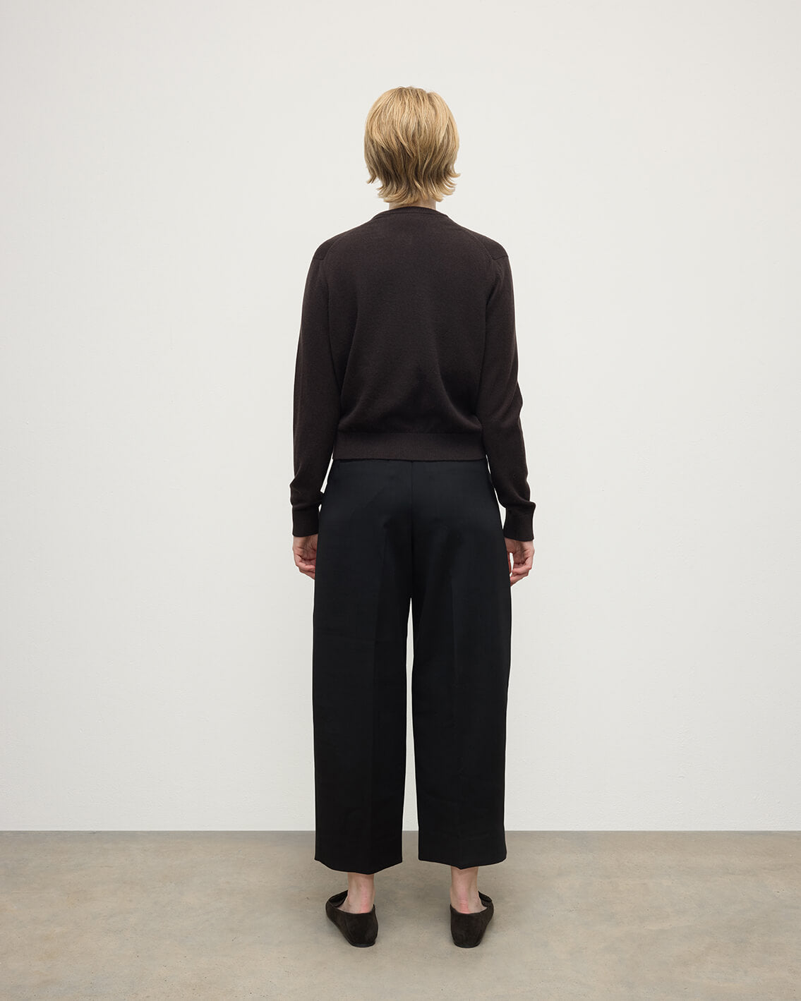Model wears Johnstons of Elgin AW25 Women's Knitwear Molasses Classic Cashmere Brown Cardigan Back KAP05573SB7290