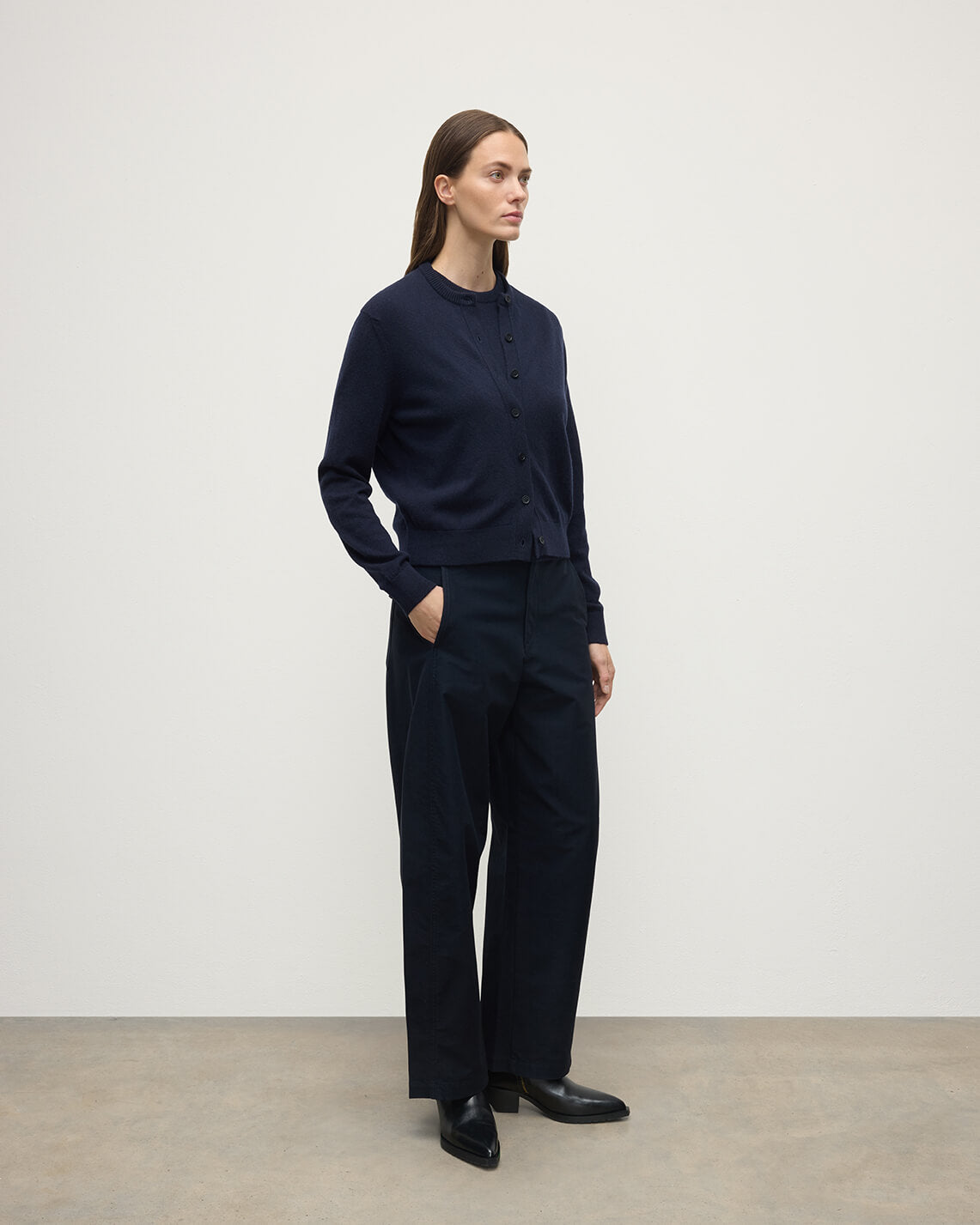 Model wears Johnstons of Elgin AW25 Women's Knitwear Dark Navy Classic Cashmere Navy Cardigan Side KAP05573SD7666