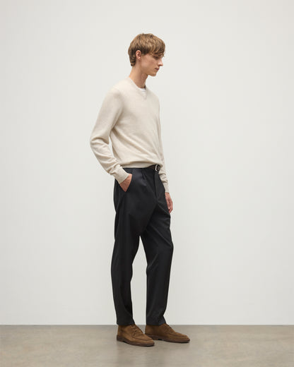 MODEL WEARS JOHNSTONS OF ELGIN MENS RORY VEE NECK CLASSIC JUMPER NATURAL 100% CASHMERE, OVER A WHITE T-SHIRT WITH NAVY TROUSERS  KAP05594HA0402