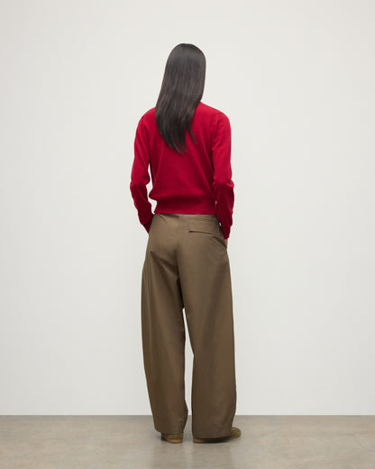 MODEL WEARS JOHNSTONS OF ELGIN WOMENS IRIS CLASSIC CREW CARDIGAN RED 100% CASHMERE OVER A WHITE VEST WITH BROWN TROUSERS AND TRAINERS  KAP05704SE5325