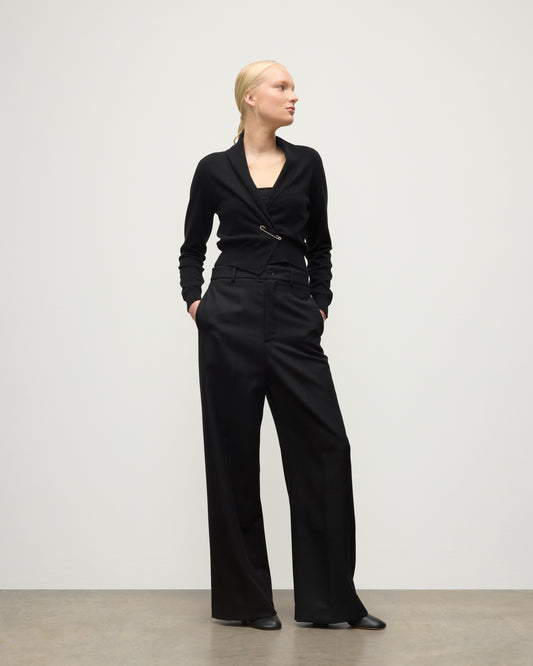 MODEL WEARS JOHNSTONS OF ELGIN WOMENS CRATHIE SHAWL CARDIGAN BLACK 100% CASHMERE WITH BLACK TROUSERS KAP05707SA7210