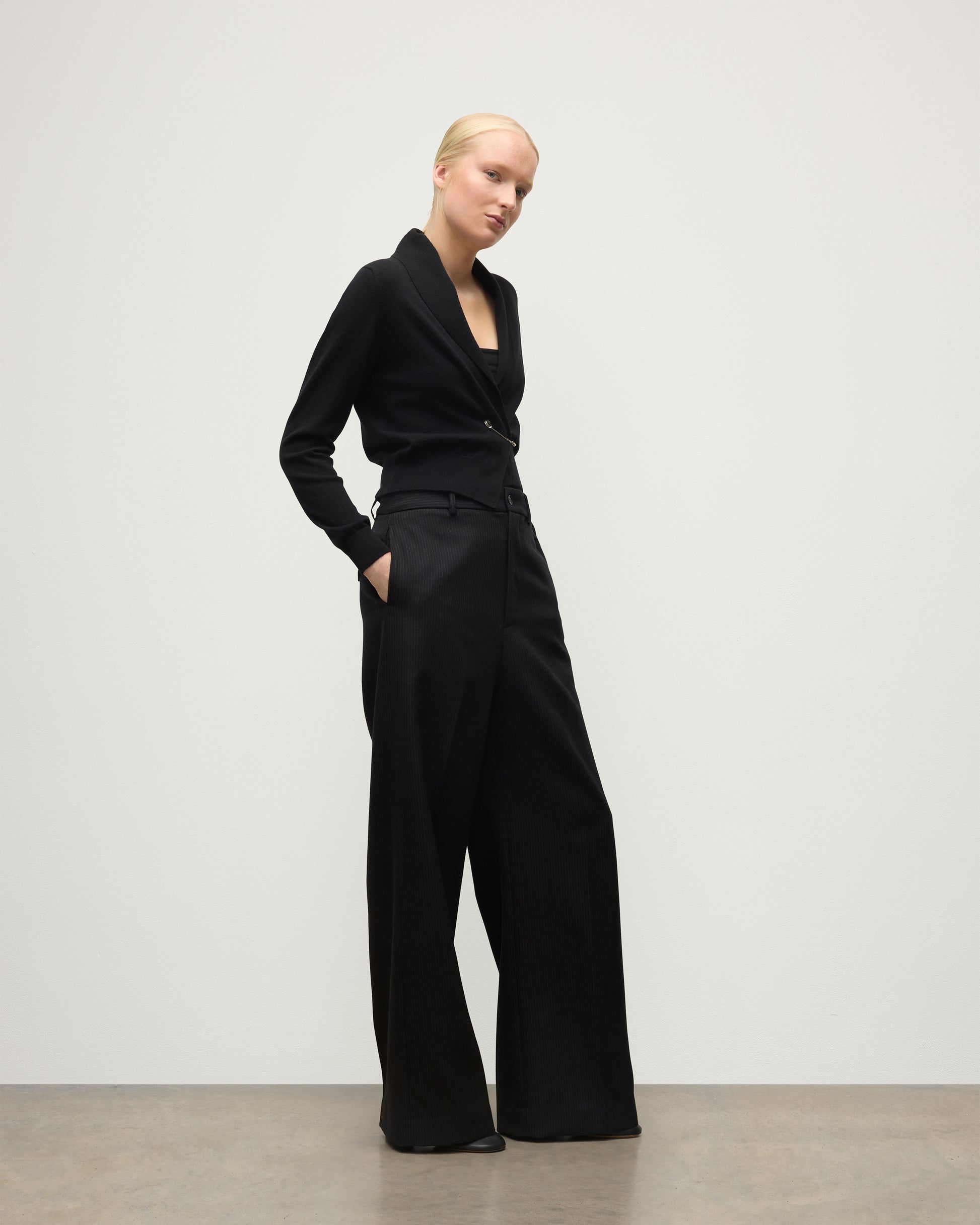 MODEL WEARS JOHNSTONS OF ELGIN WOMENS CRATHIE SHAWL CARDIGAN BLACK 100% CASHMERE WITH BLACK TROUSERS KAP05707SA7210