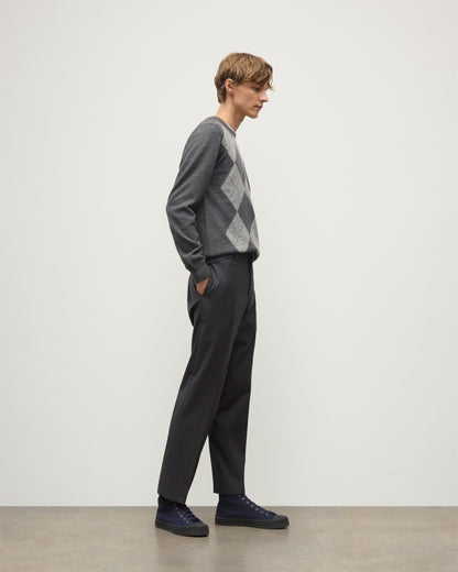 MODEL WEARS JOHNSTONS OF ELGIN MENS ARGYLL CREW SWEATER GREY & BROWN 100% CASHMERE WITH GREY TROUSERS KAP05747JU1601