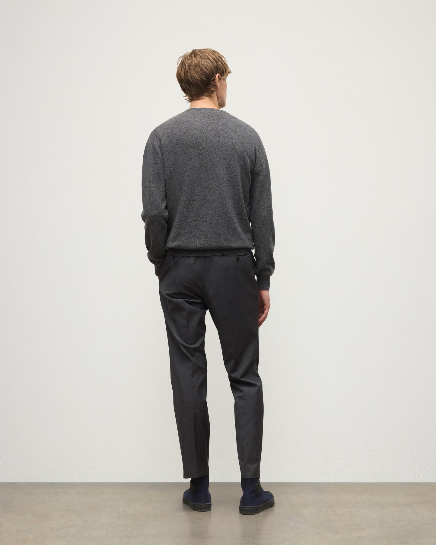 MODEL WEARS JOHNSTONS OF ELGIN MENS ARGYLL CREW SWEATER GREY & BROWN 100% CASHMERE WITH GREY TROUSERS KAP05747JU1601