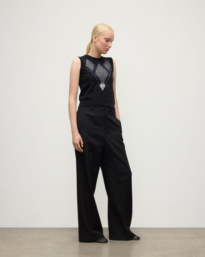 MODEL WEARING JOHNSTONS OF ELGIN WOMENS ARGYLL LE JABOTS SLEEVELESS CREW BLACK 100% CASHMERE WITH BLACK TROUSERS KAP05766JU1609