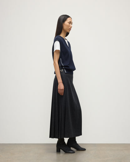 MODEL WEARS JOHYNSTONS OF ELGIN WOMENS TILDA SLEEVELESS VEE NAVY 100% CASHMERE WITH LE KILT JOHNSTONS OF ELGIN CASHMERE KILT IN CHARCOAL KAP05767Q25968