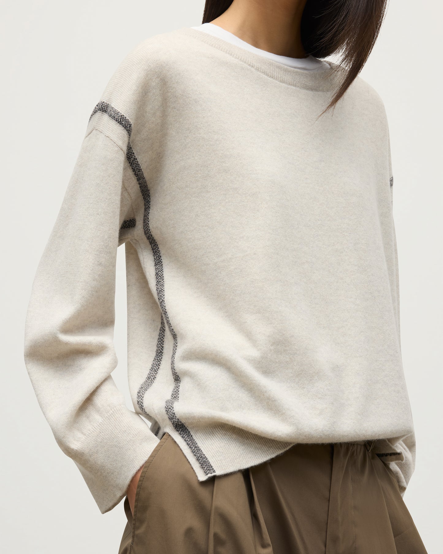 MODEL WEARS JOHNSTONS OF ELGIN WOMENS TILDA CREW SWEATER NATURAL OVER A WHITE T-SHIRT KAP05768Q25972