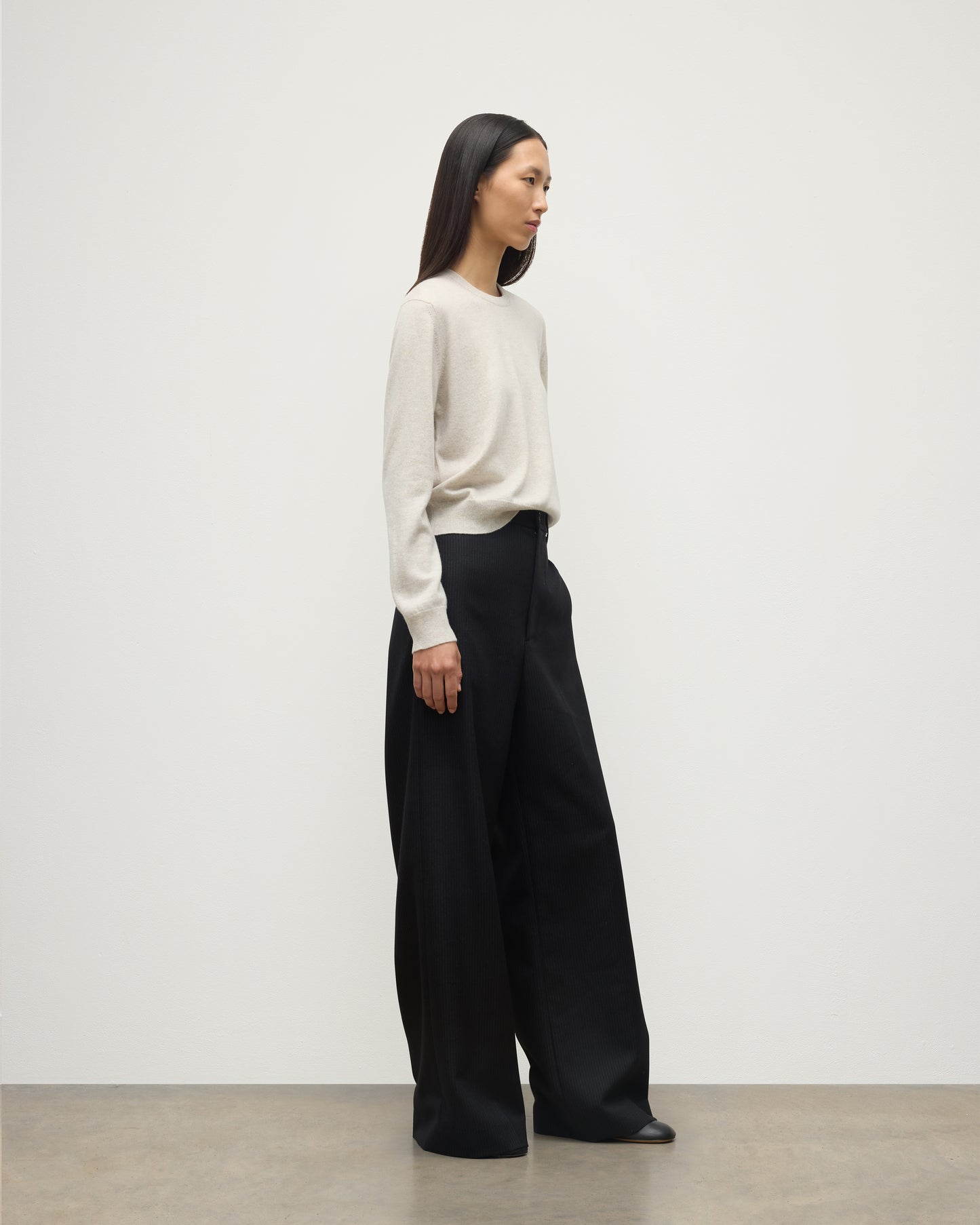 MODEL WEARS JOHNSTONS OF ELGIN WOMENS LUNAN CLASSIC CREW SWEATER NATURAL WITH BLACK WDE LEG TROUSERS KAP05784HA0402