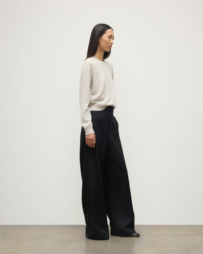 MODEL WEARS JOHNSTONS OF ELGIN WOMENS LUNAN CLASSIC CREW SWEATER NATURAL WITH BLACK WDE LEG TROUSERS KAP05784HA0402
