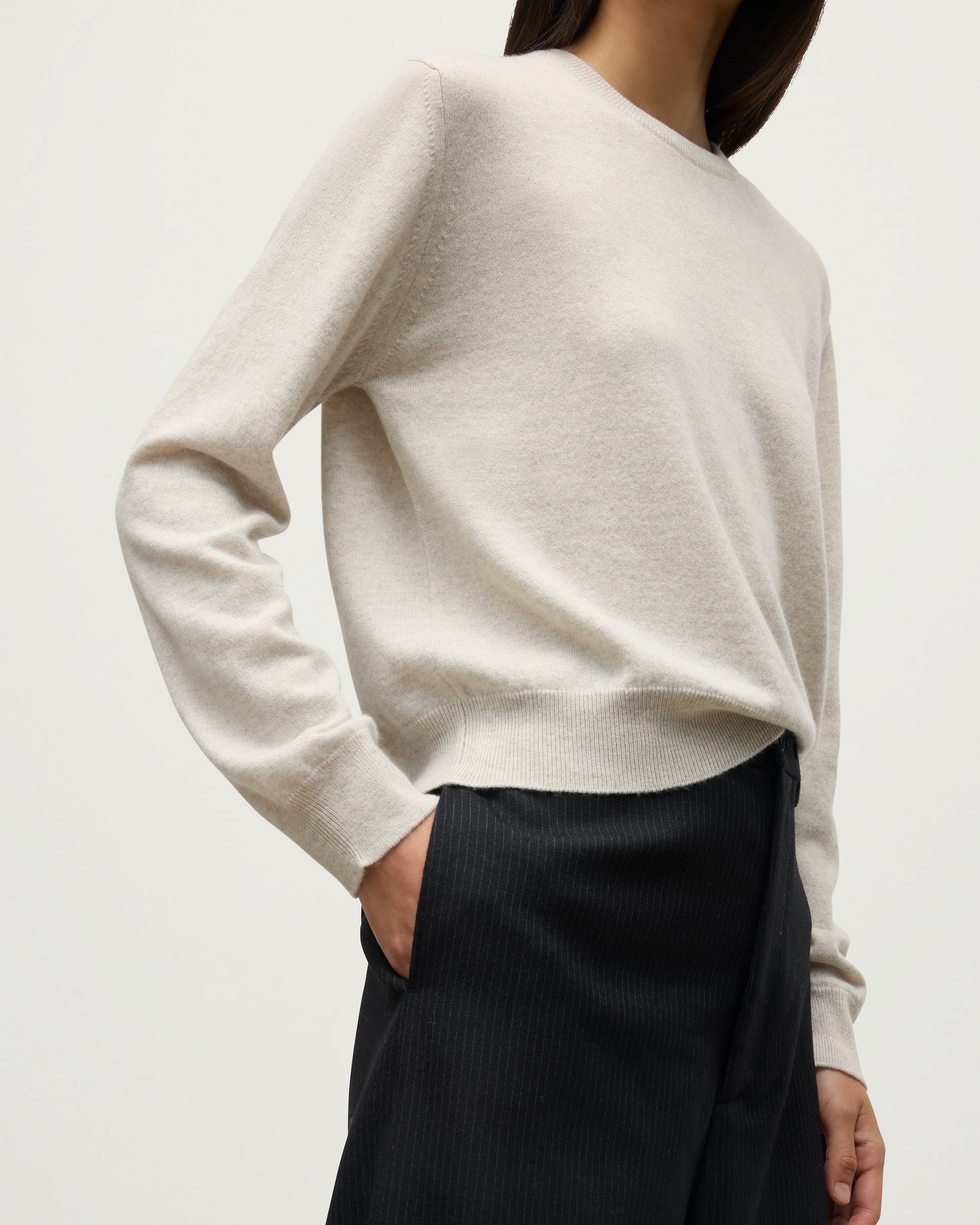 MODEL WEARS JOHNSTONS OF ELGIN WOMENS LUNAN CLASSIC CREW SWEATER NATURAL WITH BLACK WDE LEG TROUSERS KAP05784HA0402