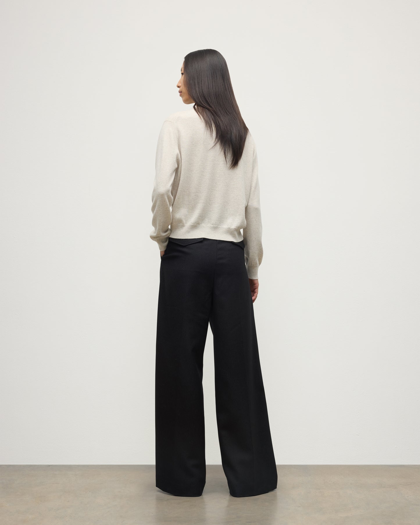 MODEL WEARS JOHNSTONS OF ELGIN WOMENS LUNAN CLASSIC CREW SWEATER NATURAL WITH BLACK WDE LEG TROUSERS KAP05784HA0402