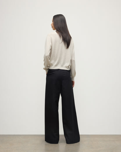 MODEL WEARS JOHNSTONS OF ELGIN WOMENS LUNAN CLASSIC CREW SWEATER NATURAL WITH BLACK WDE LEG TROUSERS KAP05784HA0402